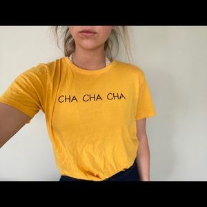 Random yellow shirt that says CHA CHA CHA.